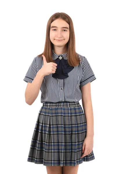 若いです美しいです女の子で学校の制服白い背景に カメラと親指に笑みを浮かべてアップ — ストック写真