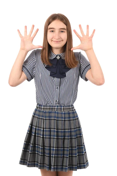若いです美しいです女の子で学校の制服で白の背景 表示され 指の番号10で指摘しながら 自信と幸せ — ストック写真