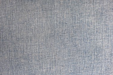 The texture of the fabric of worn jeans. High resolution photo. Full depth of field.