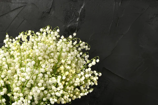 Lily of the valley flowers on black abstract background. High resolution photo. Full depth of field.