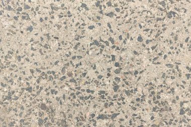 Beton doku. Farklı renkte çakıl taşları ve yaşlanma belirtileri görülebilir. Taş duvar dokusu arkaplan fotoğrafı.