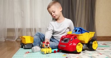 Funny baby boy with educational toy blocks. Children play at day care or preschool. Mess in kids room. Toddlers build a tower in kindergarten. Child playing with colorful toys.