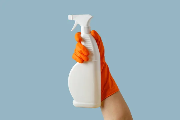 Hand Orange Rubber Glove Holding Cleaning Supplies Isolated Blue Background — Stock Photo, Image