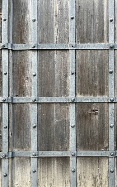 Old wooden wall with metal stripes, close up