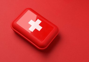 Kırmızı arkaplanda ilk yardım çantası