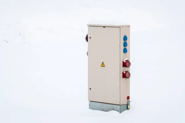 Outdoor Electric cabinet on the snow field. Electrical cabinet in the nature in the snowdrift.