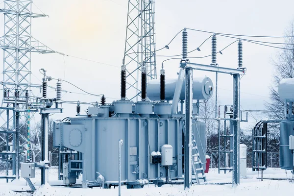 High voltage transformer substation in winter. High voltage equipment. Energy transfer technology.