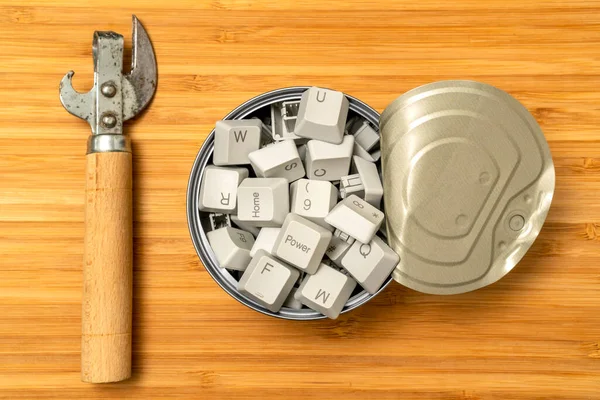 Hungry for information: can opener and tin can full of computer keyboard keys