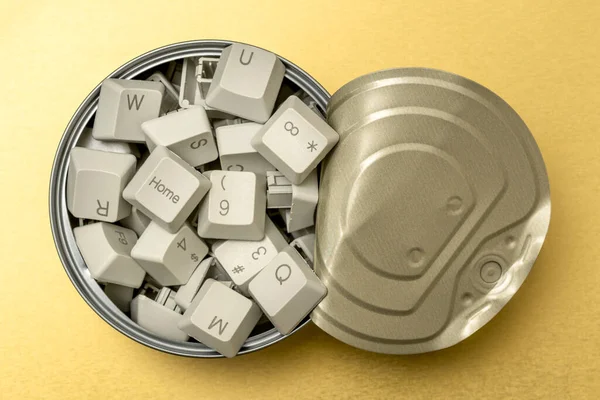 Knowledge and information seeking concept: tin can full of computer keyboard keys on the golden background