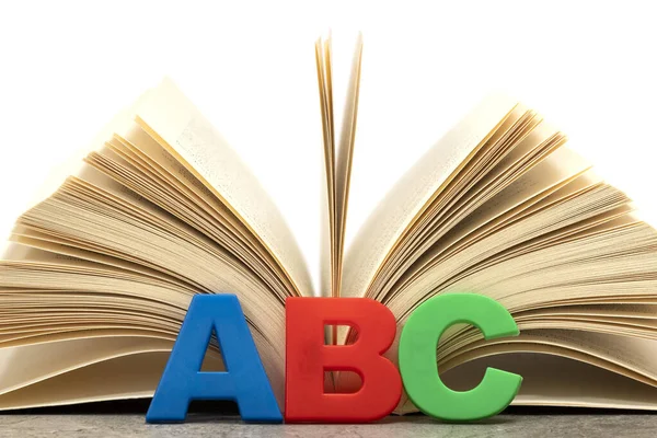 Alphabet letters ABC and open book. Education concept.