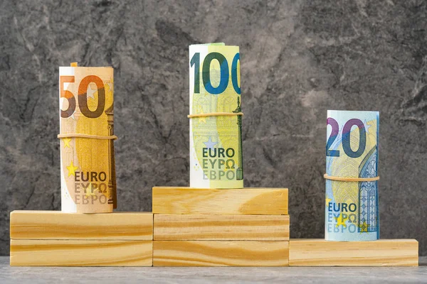 Pedestal or platform with rolls of Euro notes for honoring prize winners.Prize money concept.