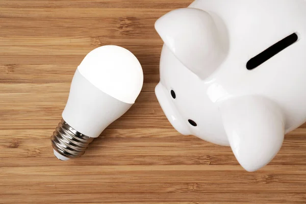 Top View Ceramic Piggy Bank Led Light Bulb Wooden Background — Stock Photo, Image