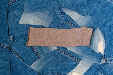 Recycling old jeans.Denim fabric for background and fashion wallpaper. DIY from jeans. Denim upcycle. Circular economy. Pile of   jean scrap with copy space. clipart