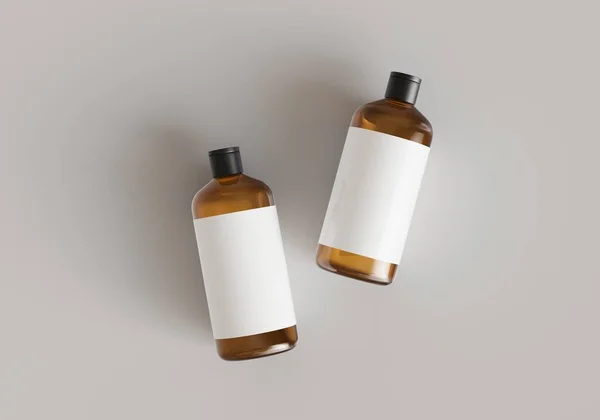 ラベル付きの2つの茶色のプラスチック製の化粧品容器 灰色の背景の正面ビューに配置されたシャンプーボトル3Dレンダリングモックアップ 商業ブランディングデザイン対応テンプレート — ストック写真