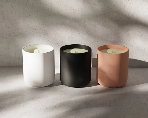 Stock image Three stylish candles offered in elegant shades of white, black, and terracotta, perfect for enhancing modern decor