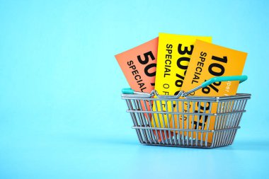 Shopping basket with discount flyers and vouchers on blue background.. Sales promocional poster. 3d illustration