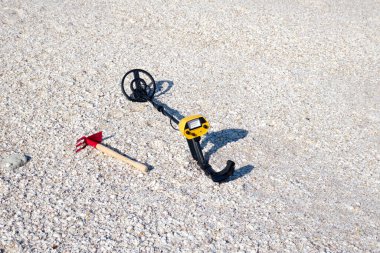 Metal detector on the sandy beach. Caspian Sea.