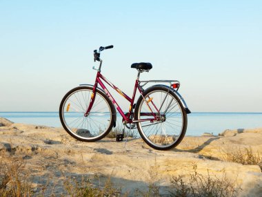 Bicycle on the rocky coast of the sea. Rocky coast of the Caspian Sea. Mangistau region. Kazakhstan. 23 September 2020 year.