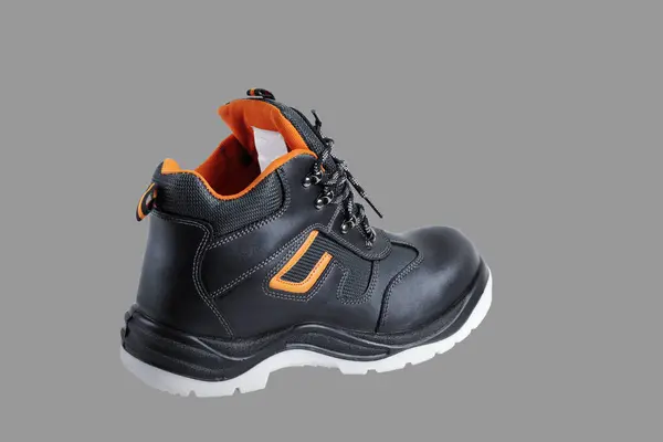 Protective safety shoe. Close-up. Isolated on a gray background.