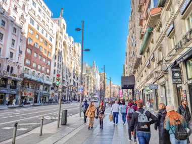 Madrid, Spain - 06 February, 2023: People walking in the Gran Via avenue. Because of its shopping centers, hotels and movie theatres, the street is know as the 