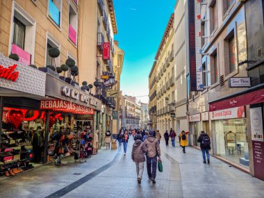 Madrid, Spain - 04 February, 2023: People walking in the Calle de Preciados street. The public street spans from Puerta del Sol to Plaza de Santo Domingo via Plaza de Callao.