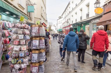 Paris, Fransa - 6 Mart 2023: Montmartre mahallesinde yürüyen insanlar. Geleneksel bölge sanatçıları, kafeleri, restoranları ve gece hayatıyla ünlüdür..