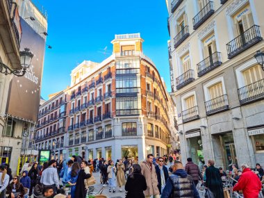 Madrid, Spain - 04 February, 2023: People walking in the Calle de Preciados street. The public street spans from Puerta del Sol to Plaza de Santo Domingo via Plaza de Callao.