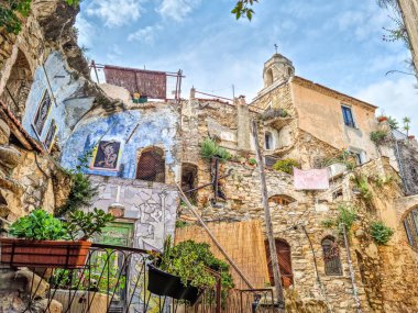 Bussana Vecchia, Italy - 05 May, 2024: Painted buildings in the center of the city. The town was abandoned due to an earthquake in 1887 and renovated and repopulated in the early 1960s.