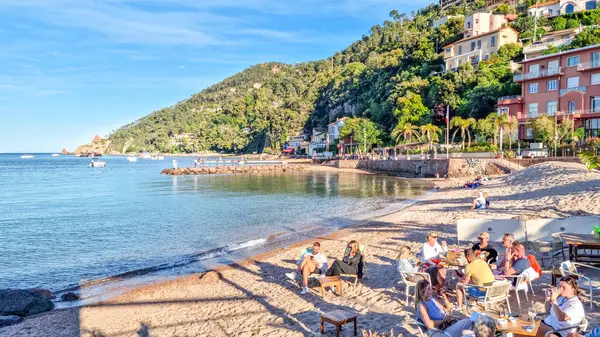 stock image Theoule sur Mer, France - 08 May, 2024: People enjoying the good weather at the beach. The city lies to the east of the Esterel Massif, on the French Riviera.