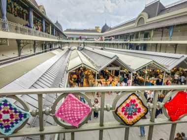 Porto, Portugal - 11 June, 2025: People walking in the Bolhao market decorated for the Festa de Sao Joao (Midsummer party). The traditional place is a neoclassic building famous for its fresh products.