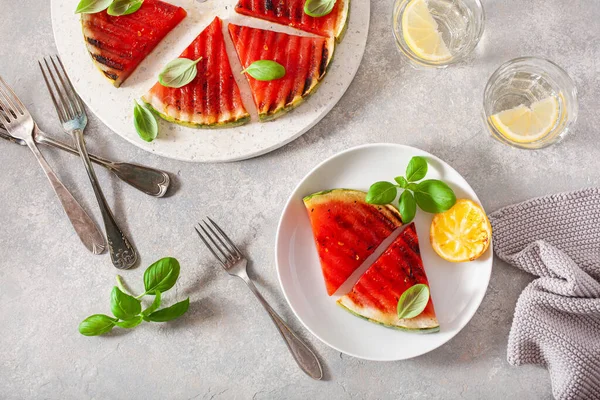 stock image grilled watermelon slices with lemon and basil. summer dessert