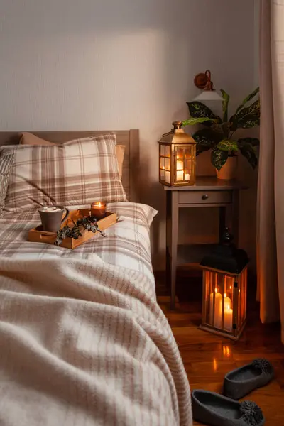 cozy scandinavian bedroom interior in natural tones, blanket candles houseplants