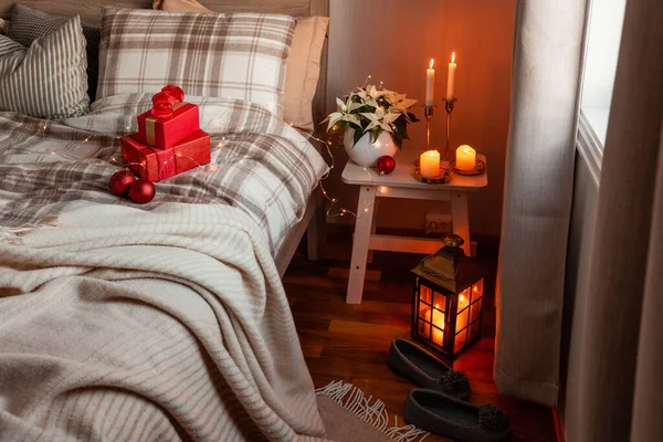 cozy scandinavian bedroom interior in natural tones, blanket candles christmas gift box