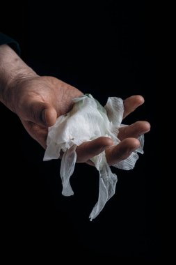 man's hand holding wilted flower, concept of melancholy sadness fatigue despair or depression