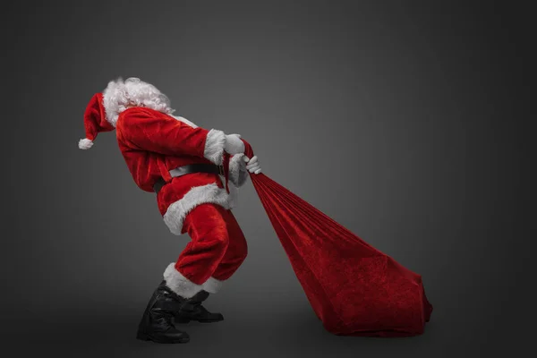 Shot Bearded Santa Big Bag Stuffed Gifts Grey Background — Stock Photo, Image