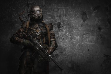 Shot of military man dressed in gas mask and ragged uniform with shotgun.