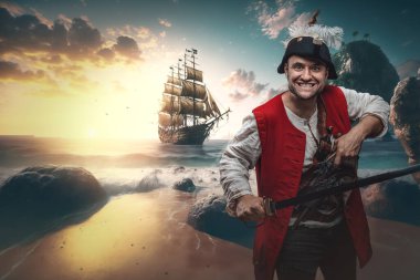 Shot of furious buccaneer dressed in costume and cocked hat with saber on shore.