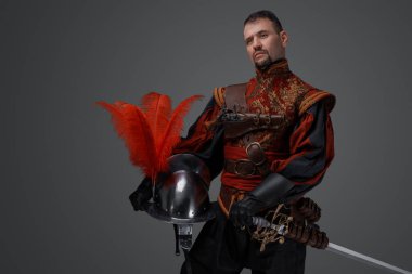 Shot of handsome musketeer man with beard dressed in stylish costume.