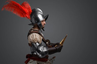 Studio shot of isolated on gray background conquistador with map. clipart