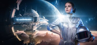 Art of cosmonaut woman dressed in silver spacesuit holding headwear against space station.