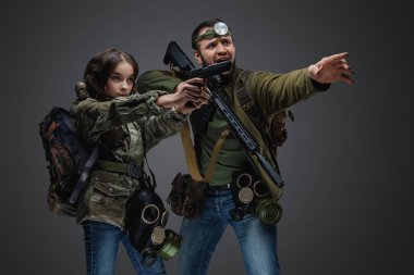 Studio shot of post apocalyptic girl teenager and man surviving after armageddon.