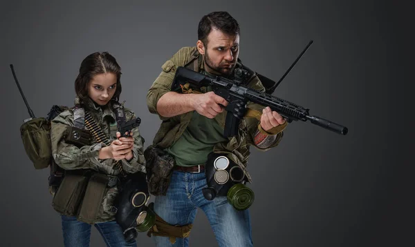 ポスト黙示録的な女の子ティーンと男とともに銃とともに灰色の背景 — ストック写真