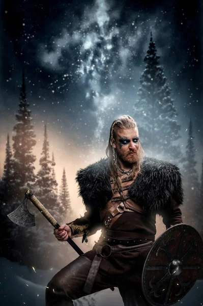 stock image Art of scandinavian warrior from past with makeup against forest and starry sky.