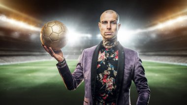 Futbol topu tutan kendine güvenen futbolcu..