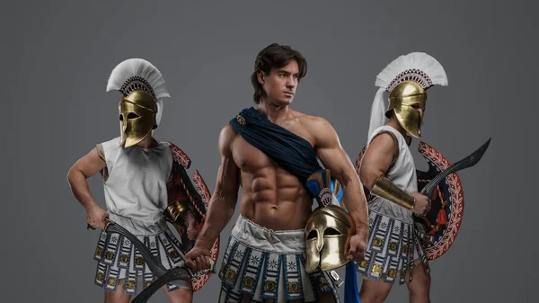 Studio shot of ancient greek soldiers with shields and plumed helmets.