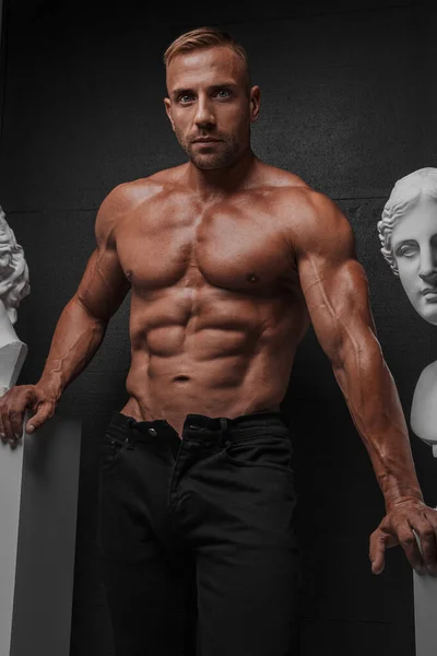 Attractive Muscular Man Black Jeans Poses Alongside Ancient Greek Sculpture — Stock Photo, Image