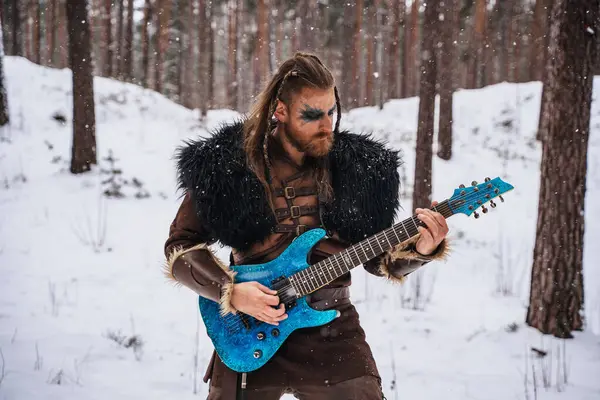Viking Inspired Musician Plays Electric Guitar Snowy Forest Embodying Fusion Stock Photo