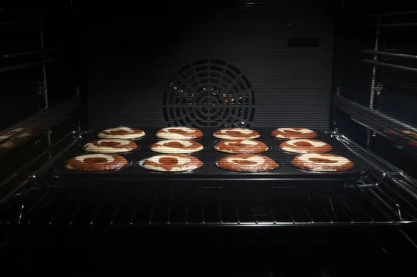 Hausgemachte Schokoladen Cupcakes Ofen Backen Süße Kuchen Garprozess Von Muffins lizenzfreie Stockbilder