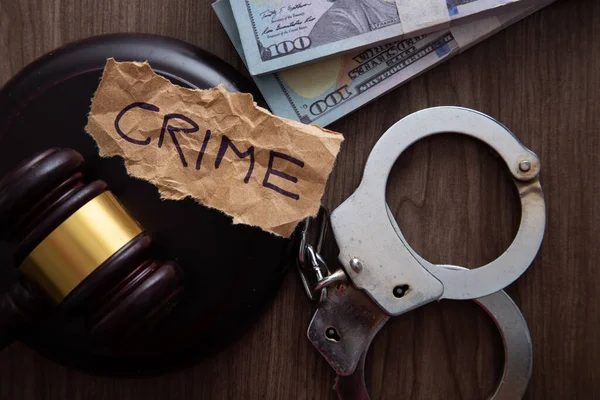 stock image Law gavel with dollars and handcuffs on wooden table background