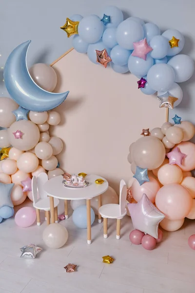 Children\'s photo zone with a lot of balloons. Decorations for boys and Girls Birthday party. Concept of children\'s birthday party. Cream-colored and pink balls.